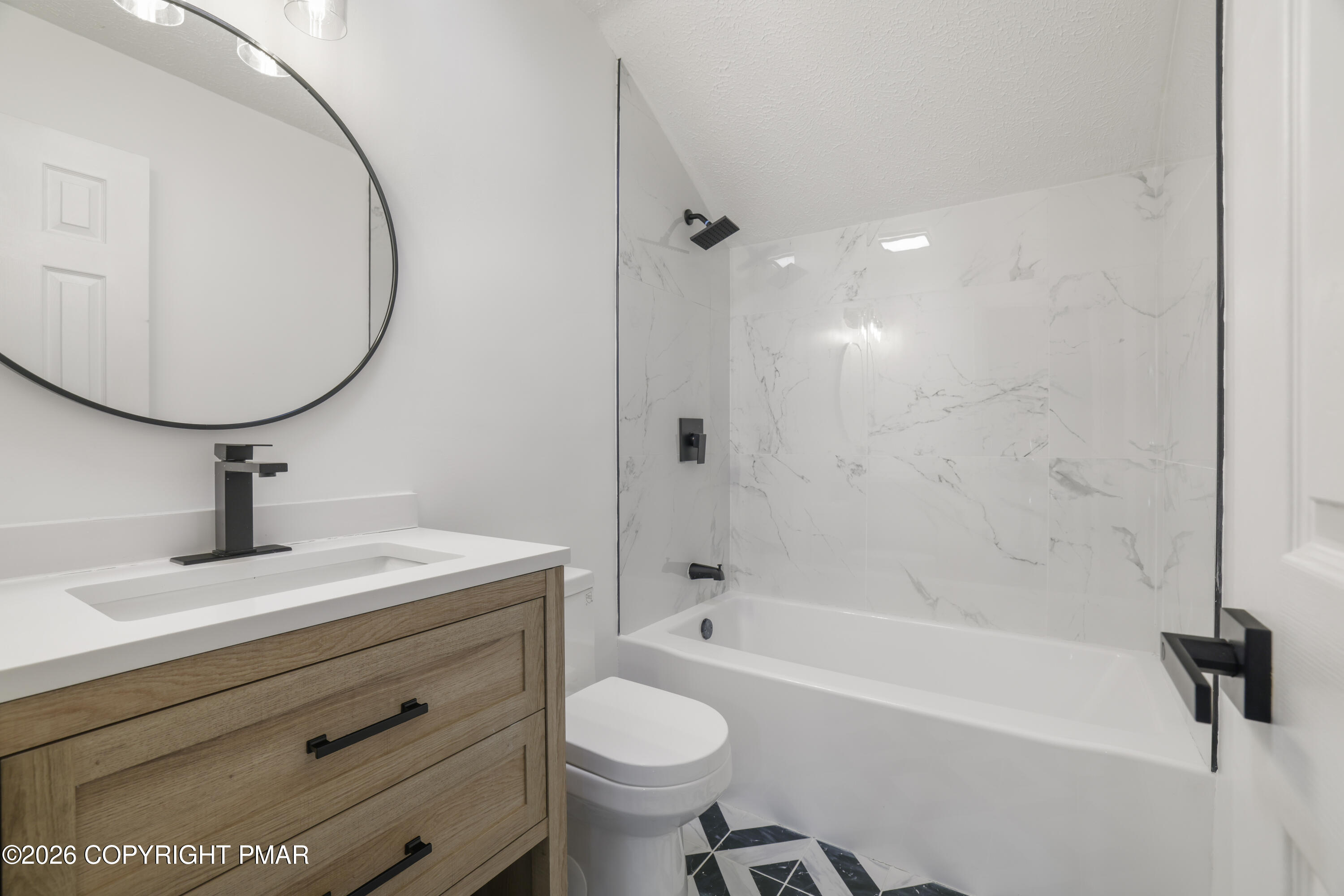 147 Pocono Boulevard Bushkill, PA 18324 - Photo 32 of 38 a bathroom with a sink a toilet and a mirror