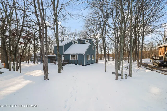 a view of a building with snow on the road