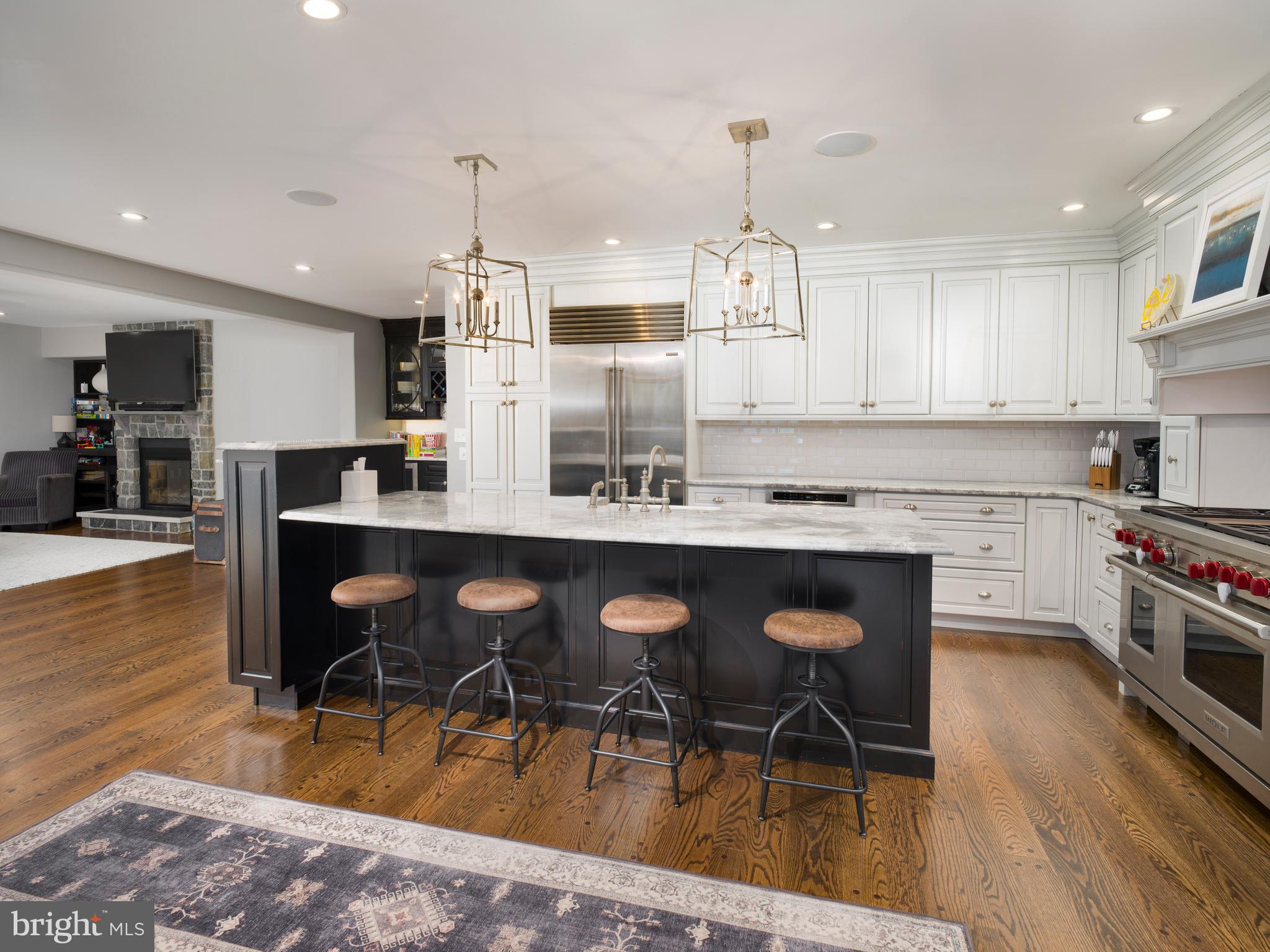 1685 Valley Road Newtown Square, PA 19073 - Photo 20 of 53 a kitchen with stainless steel appliances kitchen island granite countertop a table chairs sink and cabinets