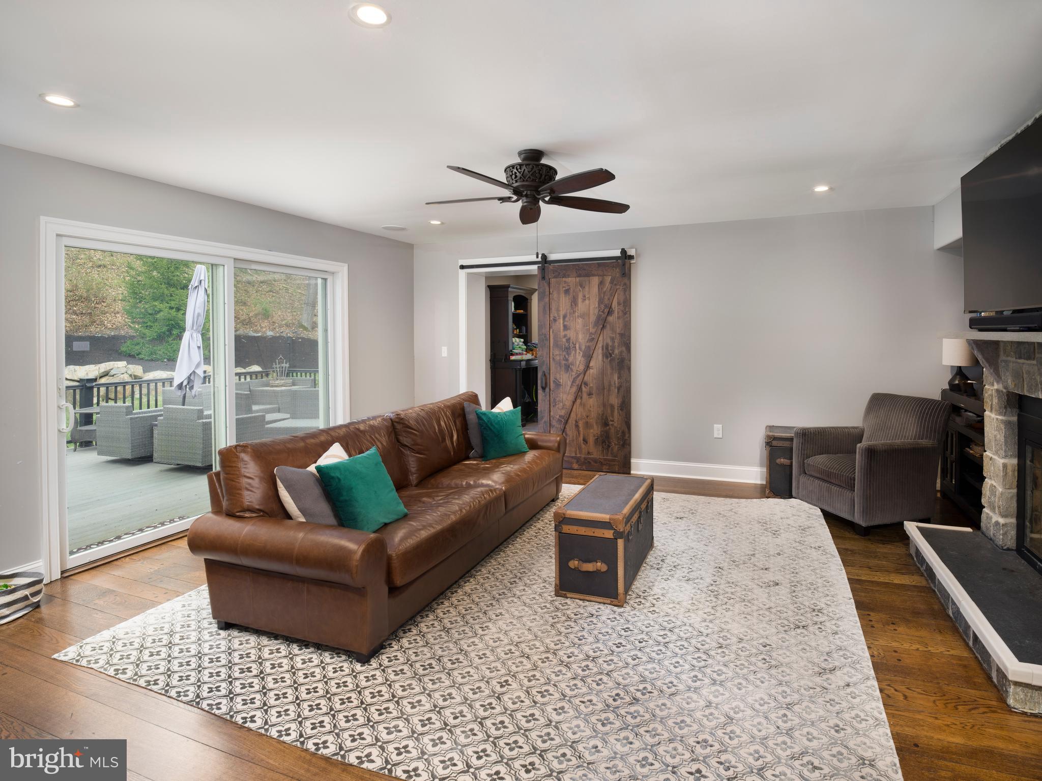 1685 Valley Road Newtown Square, PA 19073 - Photo 27 of 53 a living room with furniture a flat screen tv and a table