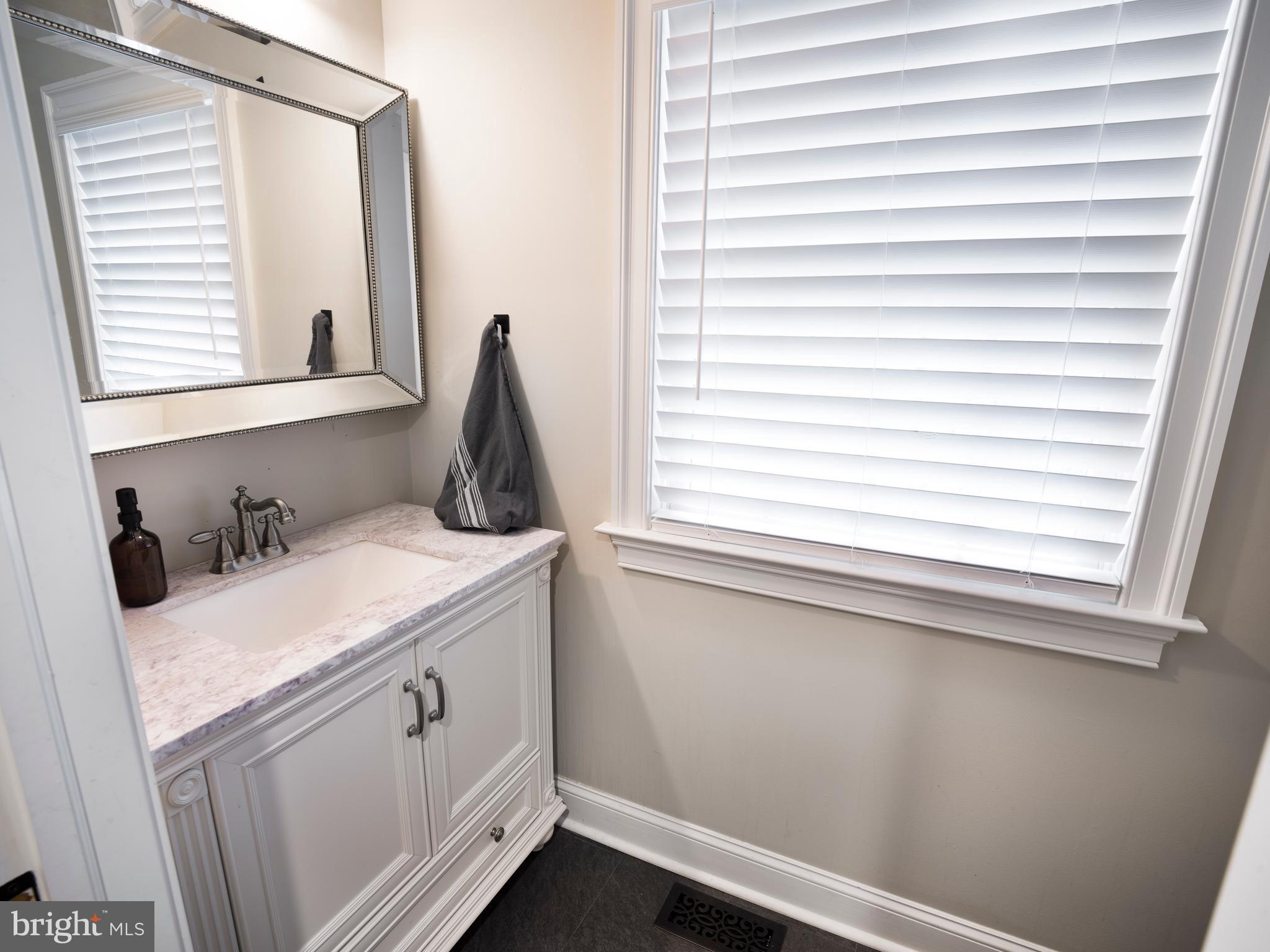1685 Valley Road Newtown Square, PA 19073 - Photo 29 of 53 a bathroom with a granite countertop sink and a window