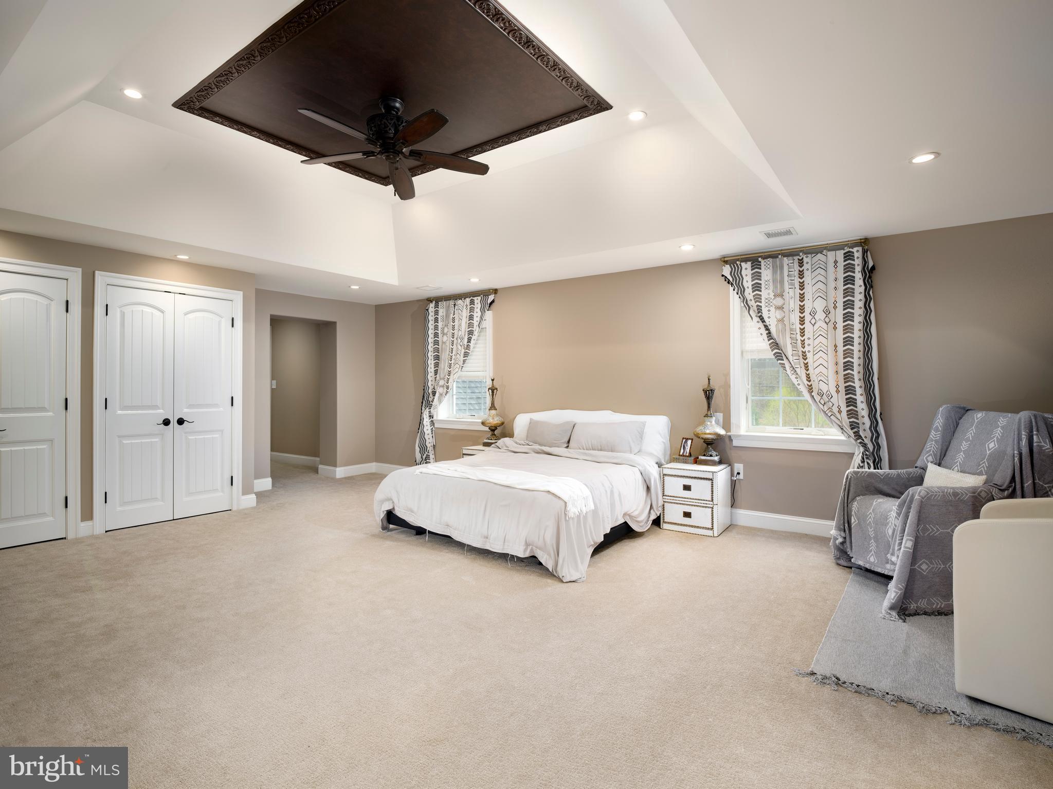 1685 Valley Road Newtown Square, PA 19073 - Photo 35 of 53 a spacious bedroom with a bed a couch and a ceiling fan