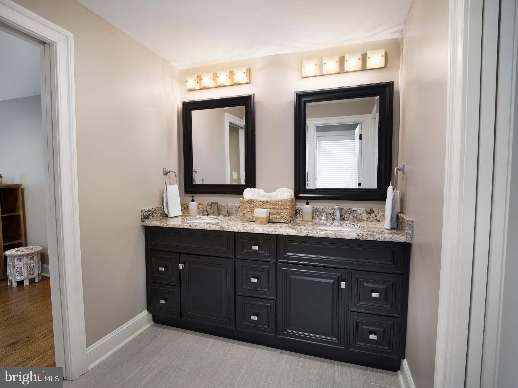 1685 Valley Road Newtown Square, PA 19073 - Photo 45 of 53 a bathroom with a sink vanity and mirror