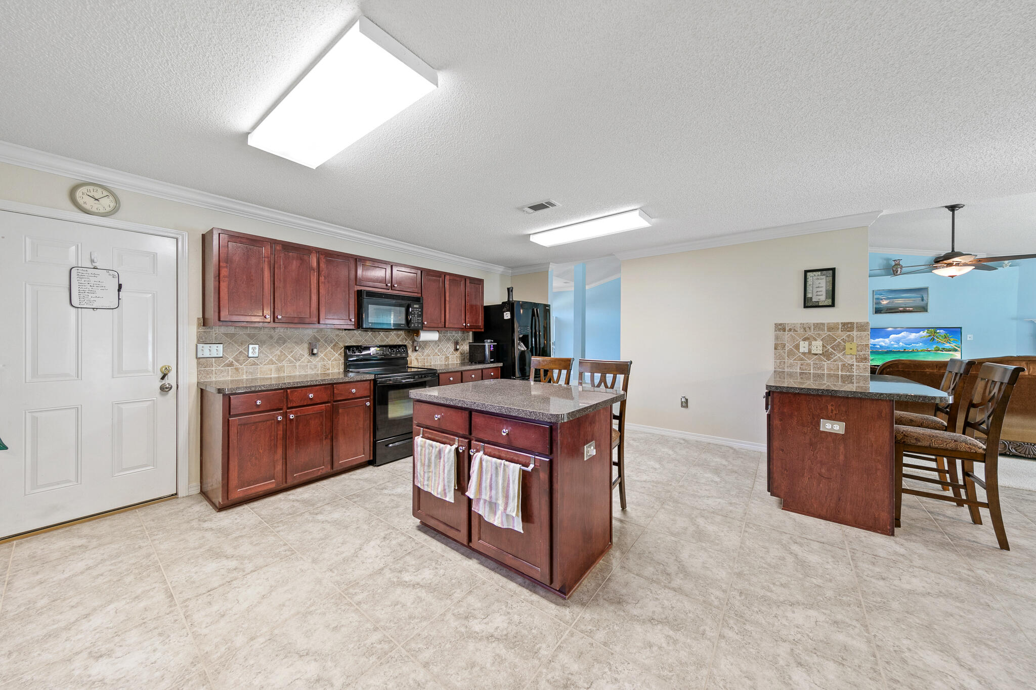 6735 Britt Street Navarre, FL 32566 - Photo 15 of 42 a kitchen with stainless steel appliances granite countertop a stove top oven a sink a counter top space and cabinets