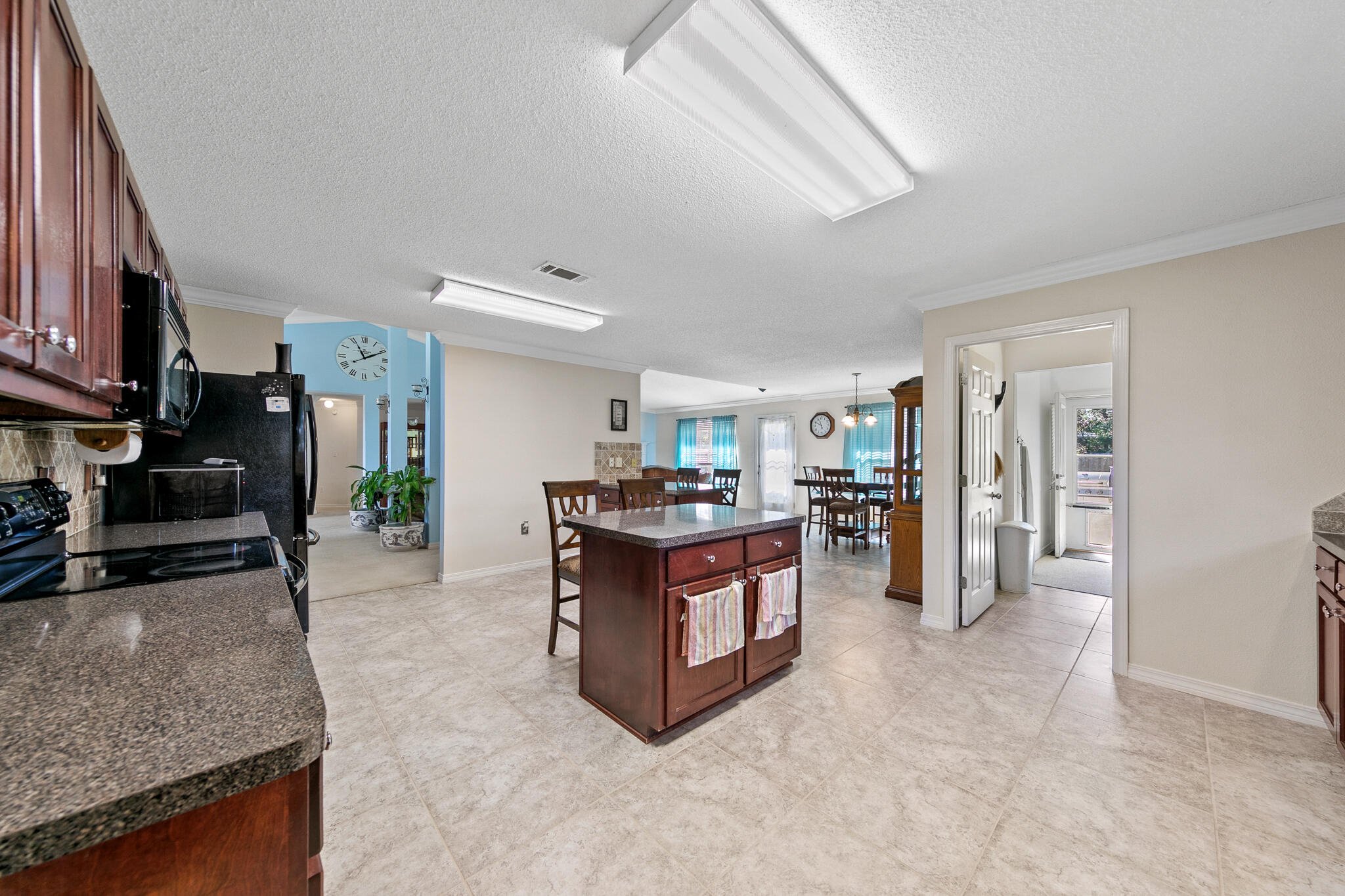 6735 Britt Street Navarre, FL 32566 - Photo 16 of 42 a living room with furniture and a kitchen