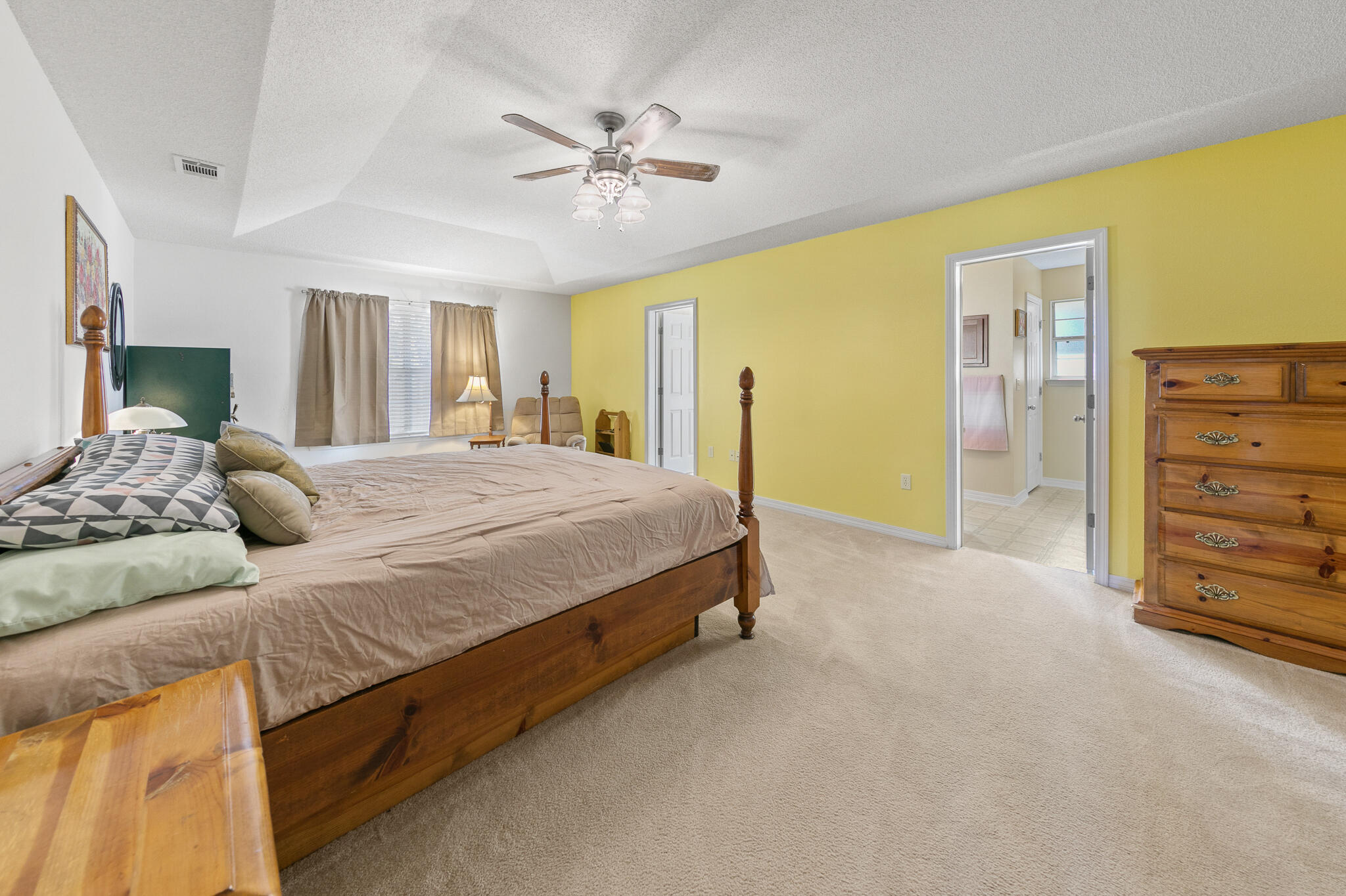 6735 Britt Street Navarre, FL 32566 - Photo 20 of 42 a bedroom with a bed and a chandelier