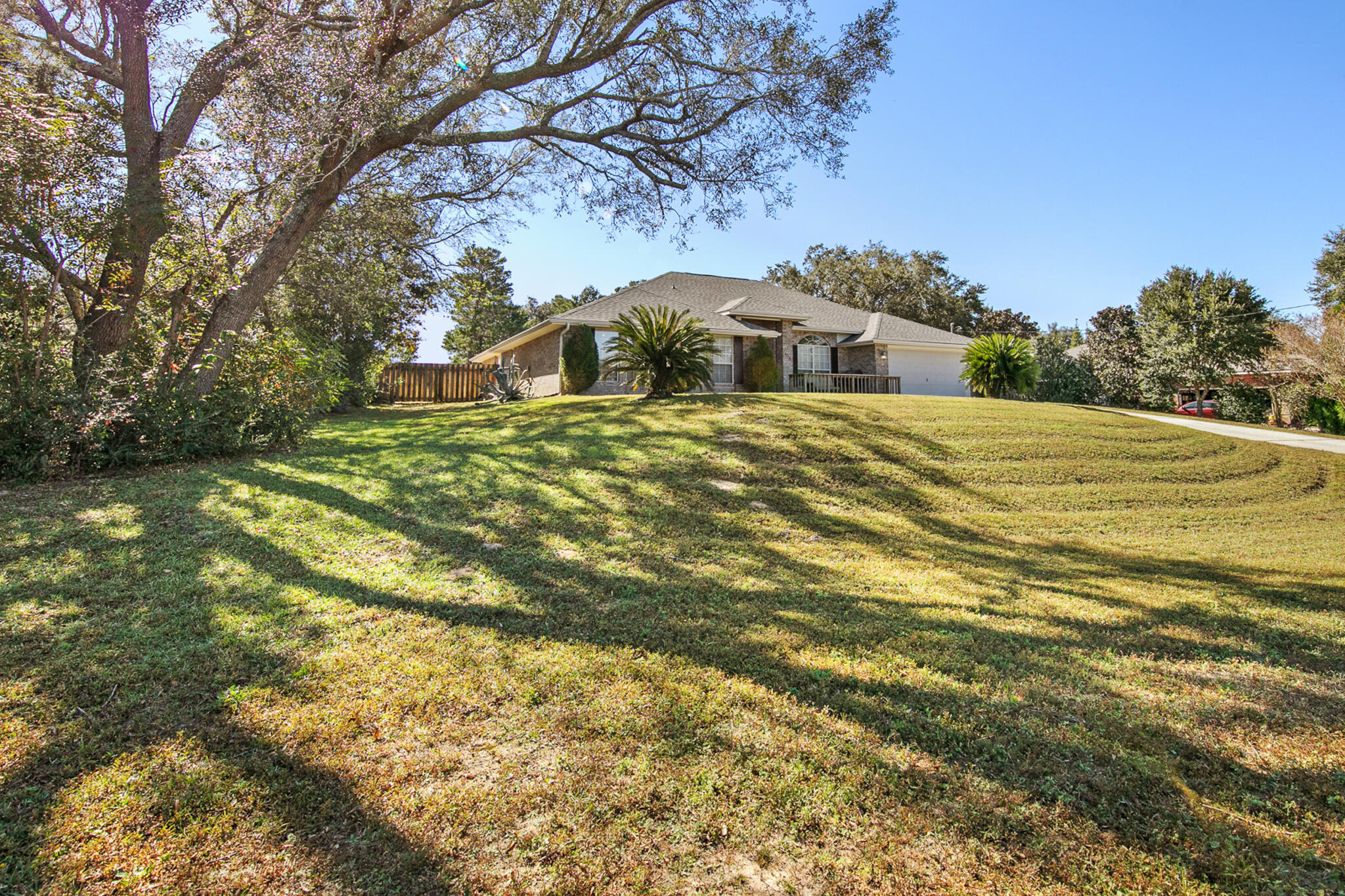 6735 Britt Street Navarre, FL 32566 - Photo 2 of 42 a front view of a house with a yard