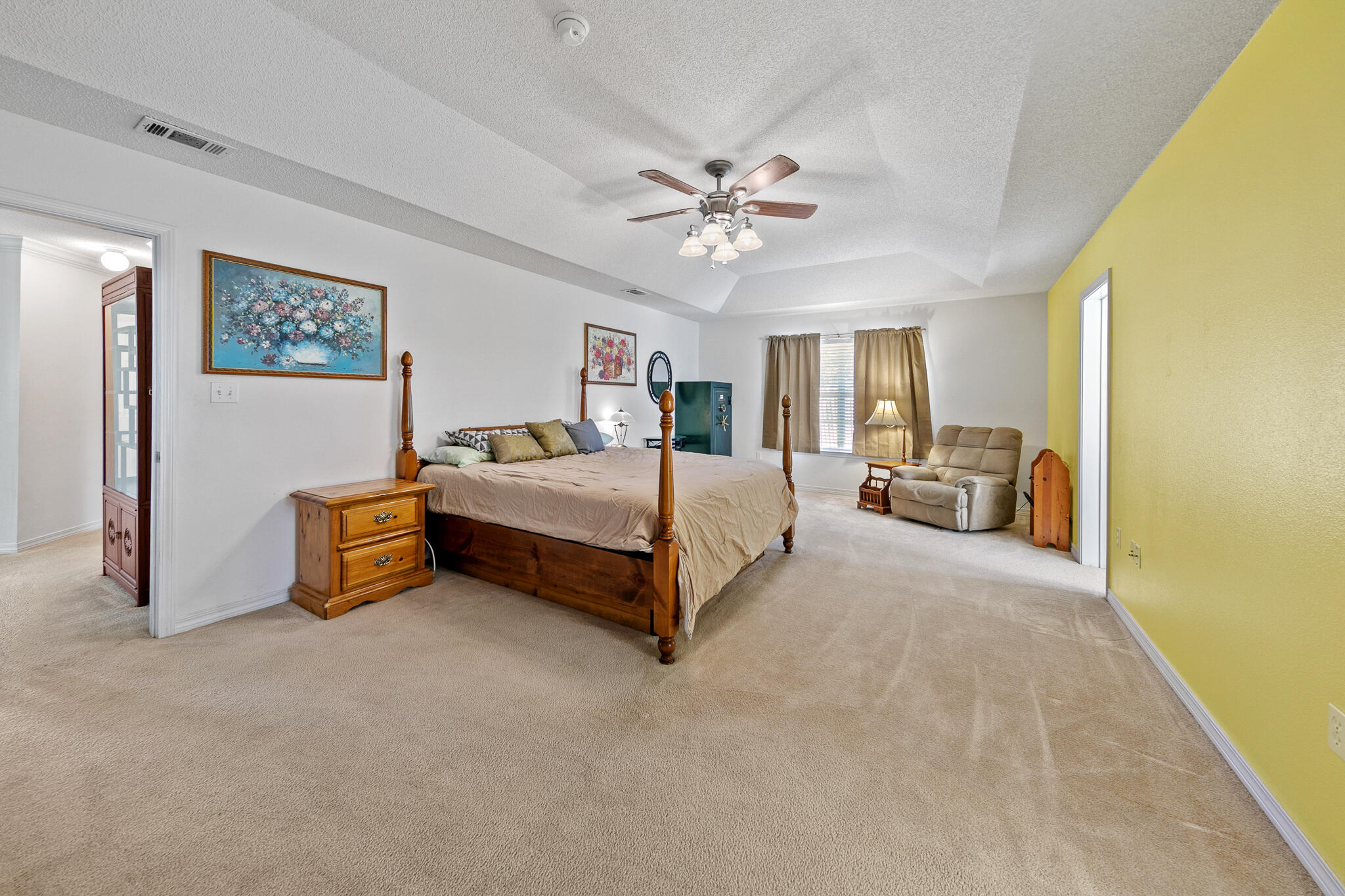6735 Britt Street Navarre, FL 32566 - Photo 21 of 42 a spacious bedroom with a bed and a chandelier