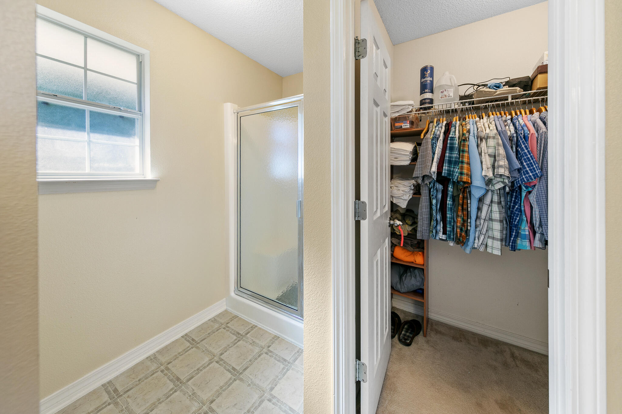 6735 Britt Street Navarre, FL 32566 - Photo 25 of 42 a view of walk in closet with clothes and shoes