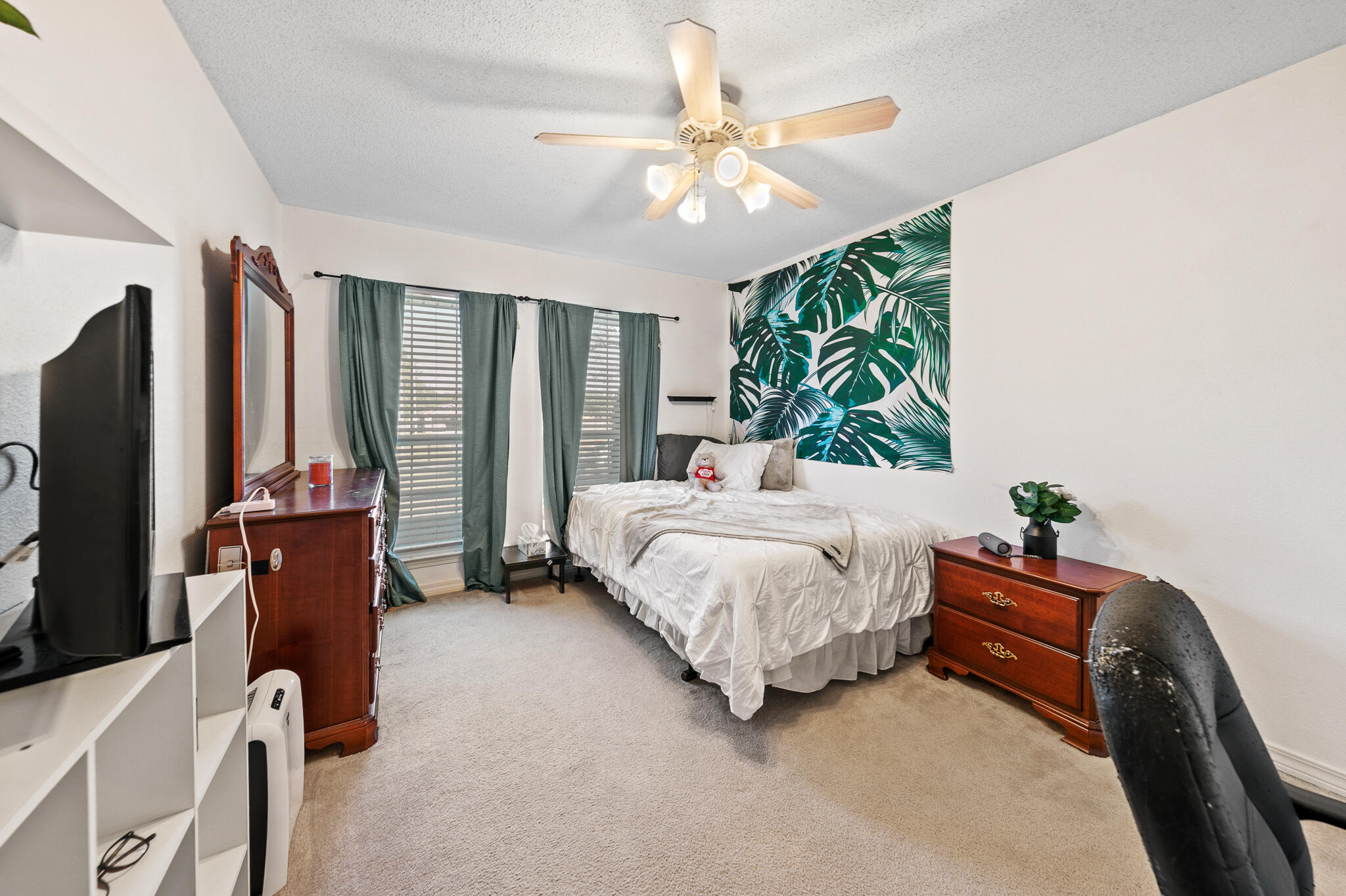 6735 Britt Street Navarre, FL 32566 - Photo 27 of 42 a bedroom with a bed and a flat tv screen on dresser
