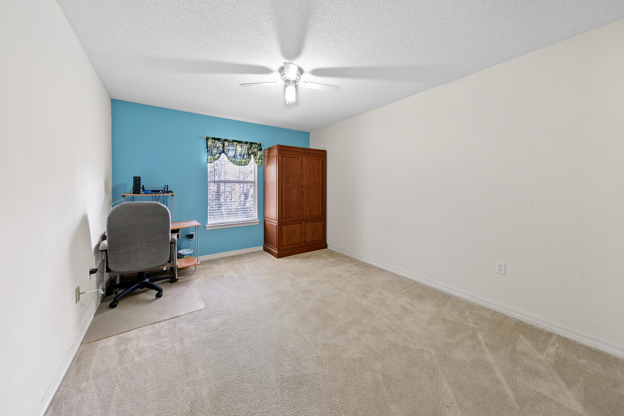 6735 Britt Street Navarre, FL 32566 - Photo 30 of 42 a room with a chair and a chandelier