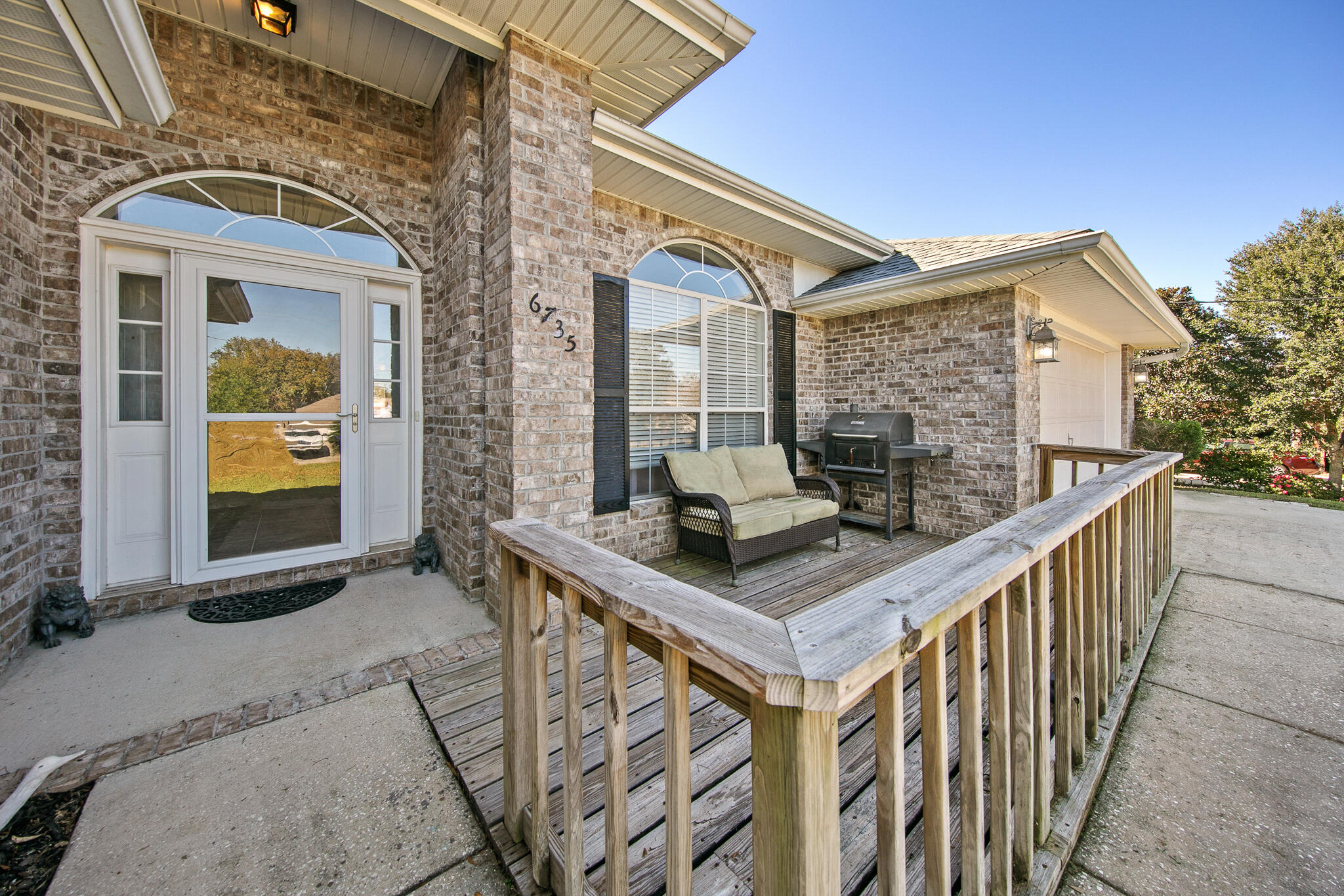 6735 Britt Street Navarre, FL 32566 - Photo 3 of 42 a balcony view with a fireplace and a table