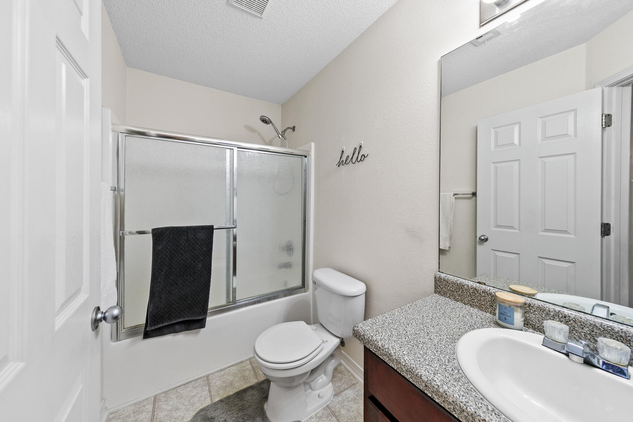 6735 Britt Street Navarre, FL 32566 - Photo 34 of 42 a bathroom with a granite countertop sink toilet and shower