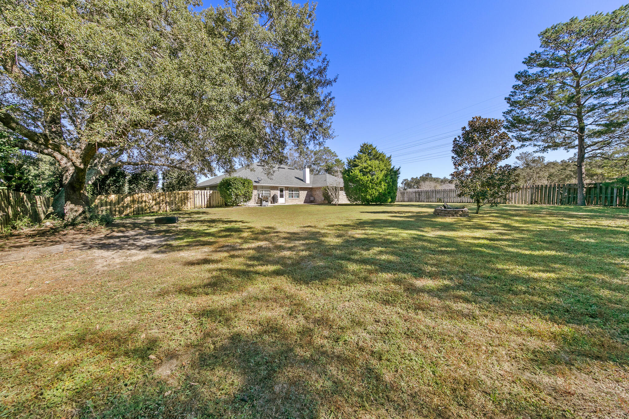 6735 Britt Street Navarre, FL 32566 - Photo 37 of 42 a view of a yard with a tree