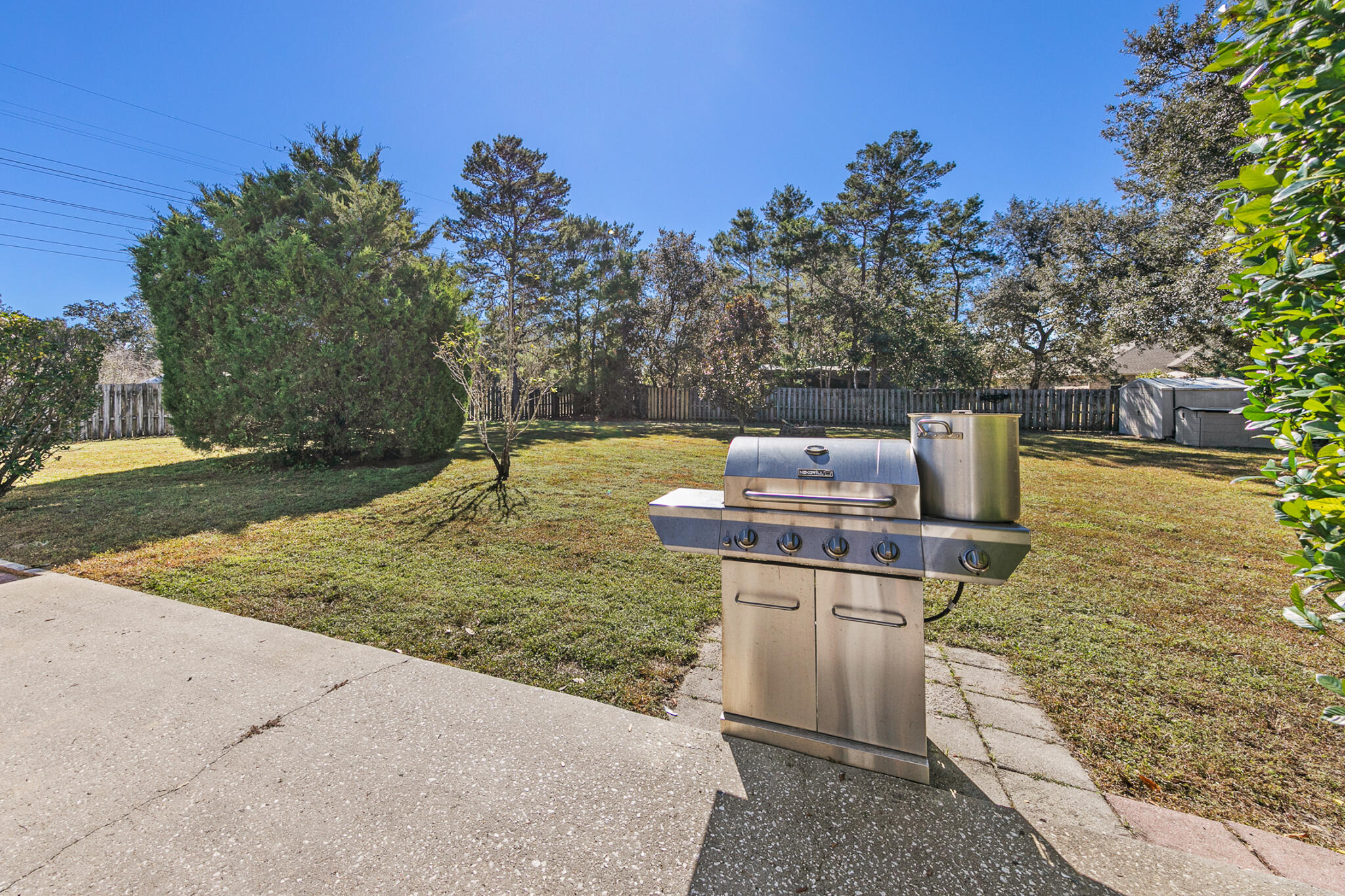 6735 Britt Street Navarre, FL 32566 - Photo 39 of 42 a view of a fire pit with trees