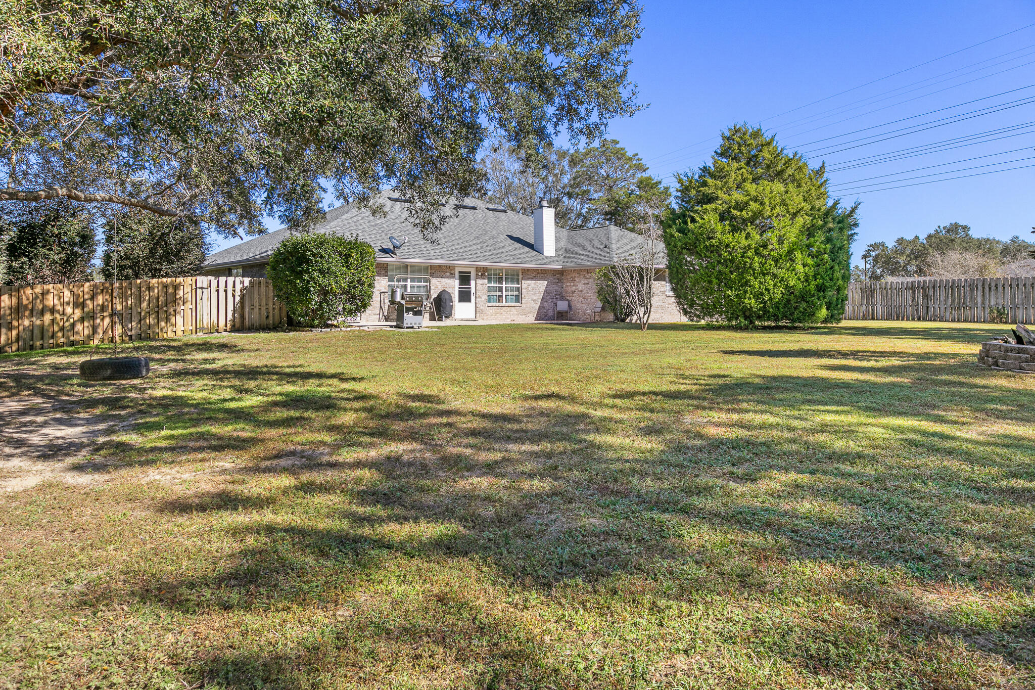 6735 Britt Street Navarre, FL 32566 - Photo 40 of 42 a big yard with trees in front of it