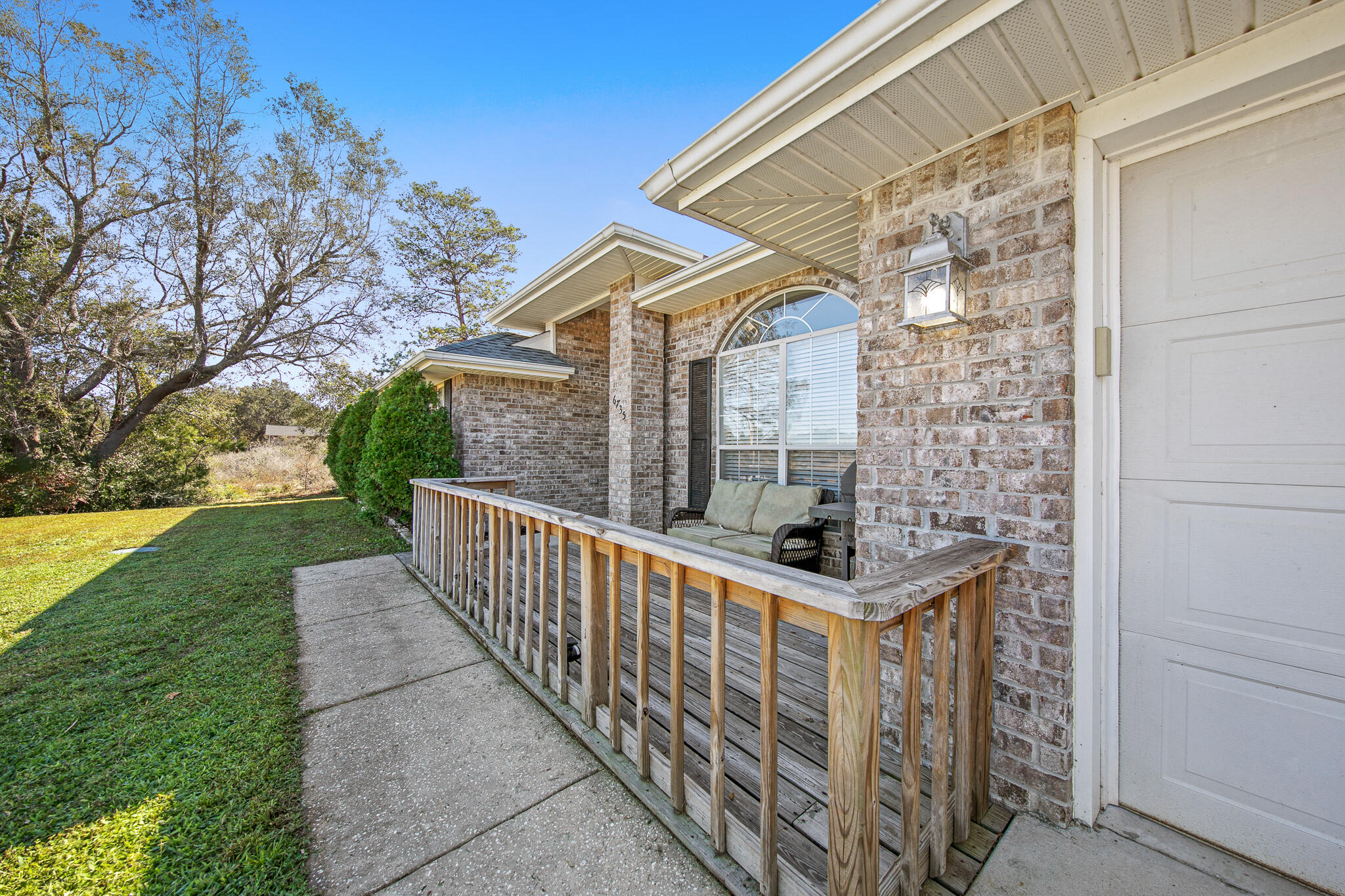 6735 Britt Street Navarre, FL 32566 - Photo 4 of 42 a view of a balcony with wooden fence and floor
