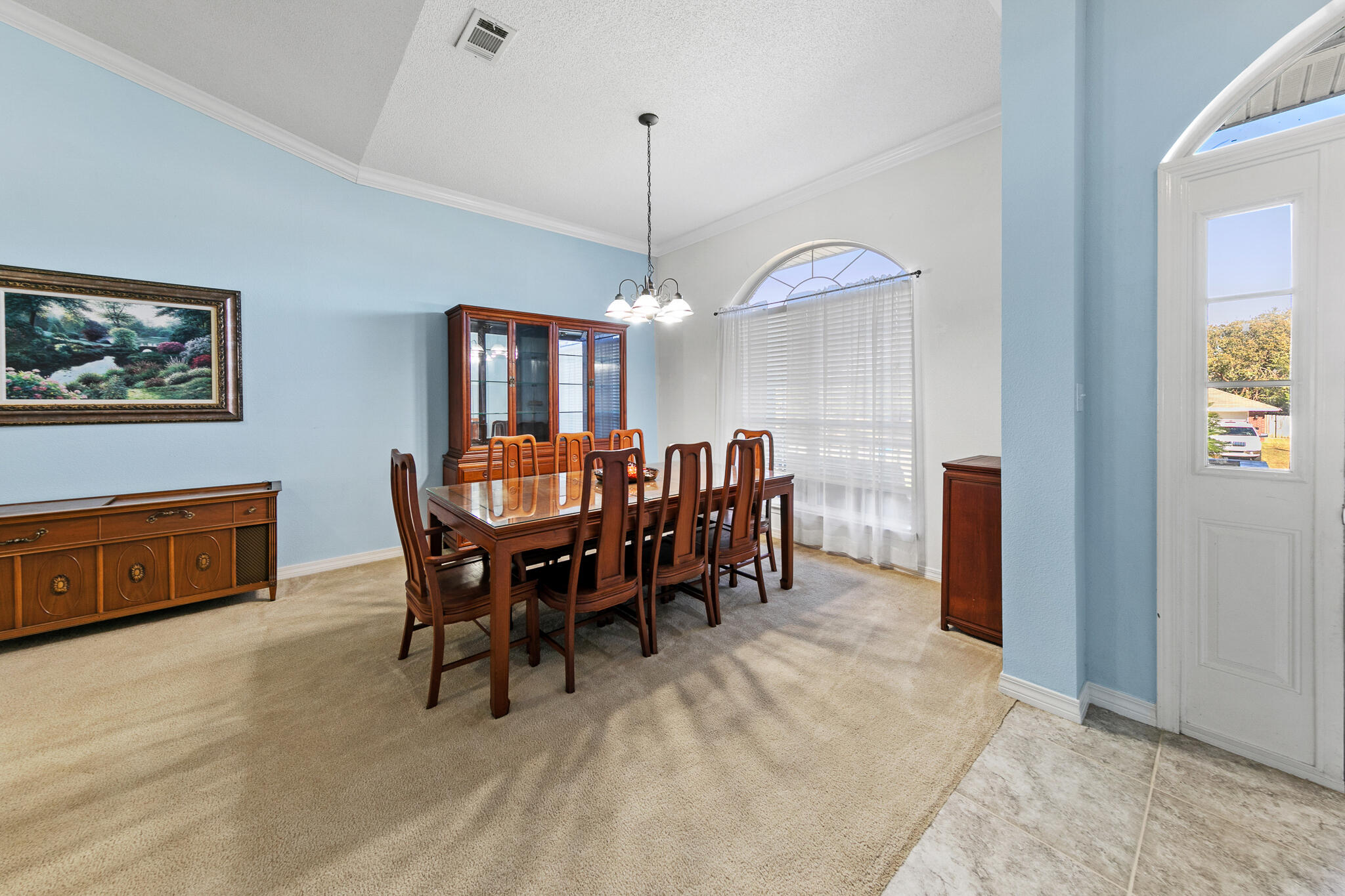 6735 Britt Street Navarre, FL 32566 - Photo 6 of 42 a view of a dining room with furniture and chandelier
