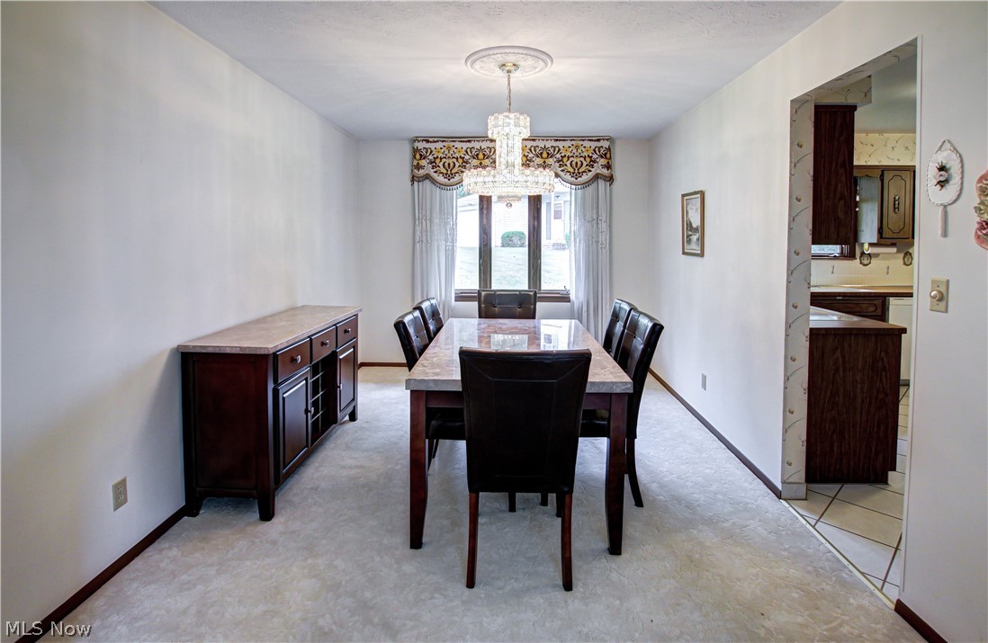 6013 Rousseau Drive Parma, OH 44129 - Photo 18 of 50 Tiled dining room featuring a chandelier