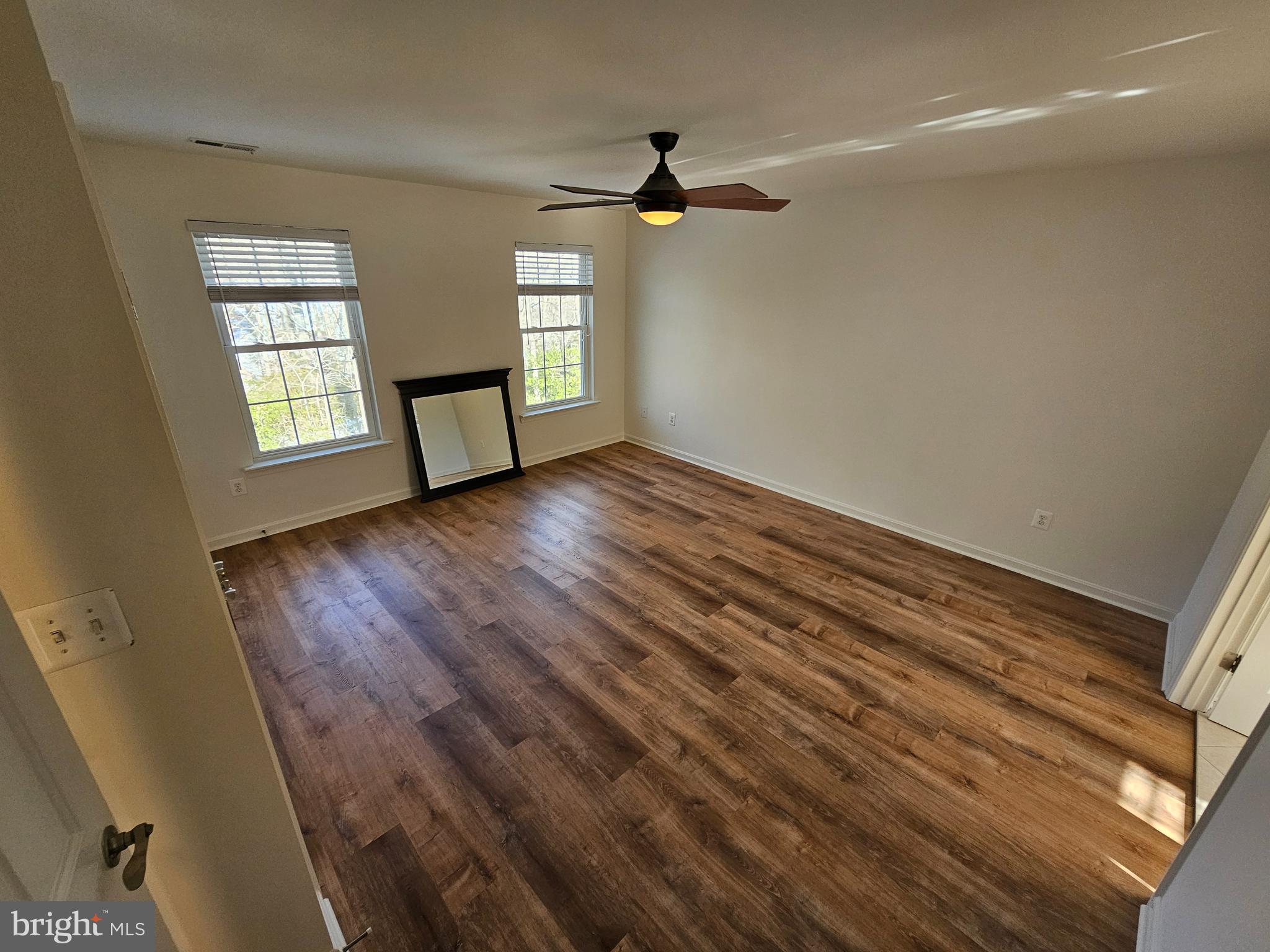 12560 Sagebrush Drive Lusby, MD 20657 - Photo 18 of 43 wooden floor in an empty room with a window
