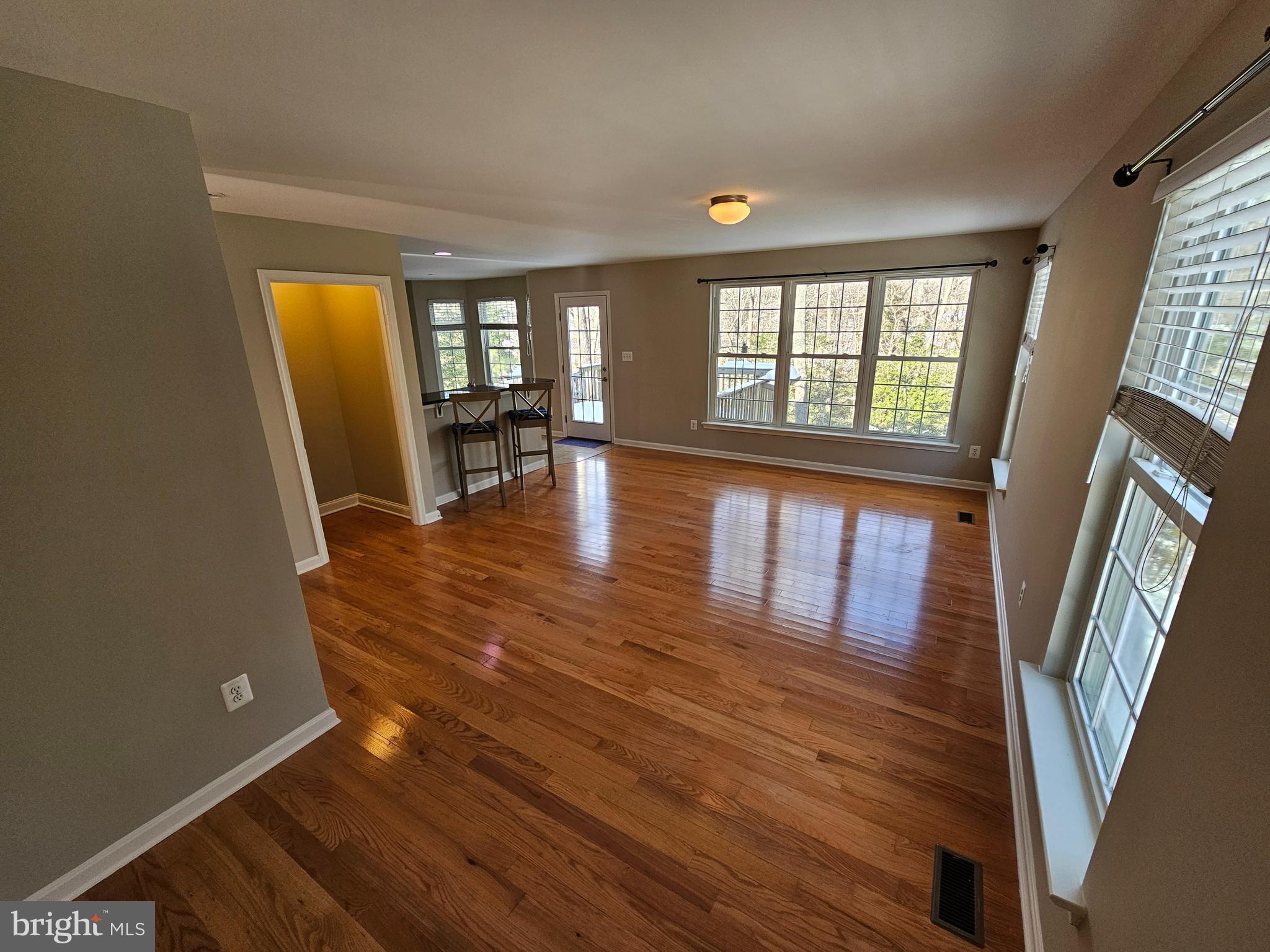 12560 Sagebrush Drive Lusby, MD 20657 - Photo 3 of 43 a view of an empty room with wooden floor and a window