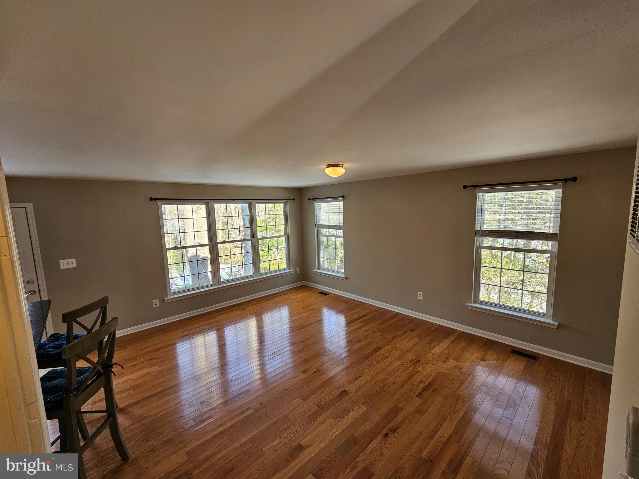 12560 Sagebrush Drive Lusby, MD 20657 - Photo 4 of 43 a view of an empty room with wooden floor and a window