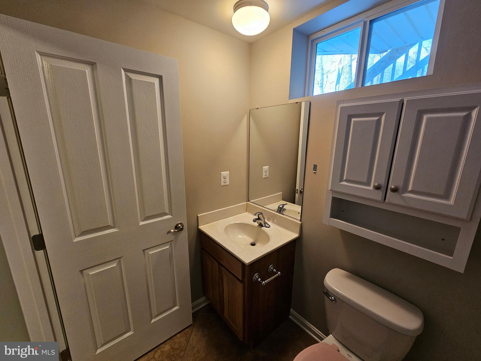 12560 Sagebrush Drive Lusby, MD 20657 - Photo 41 of 43 a bathroom with a sink a toilet and mirror