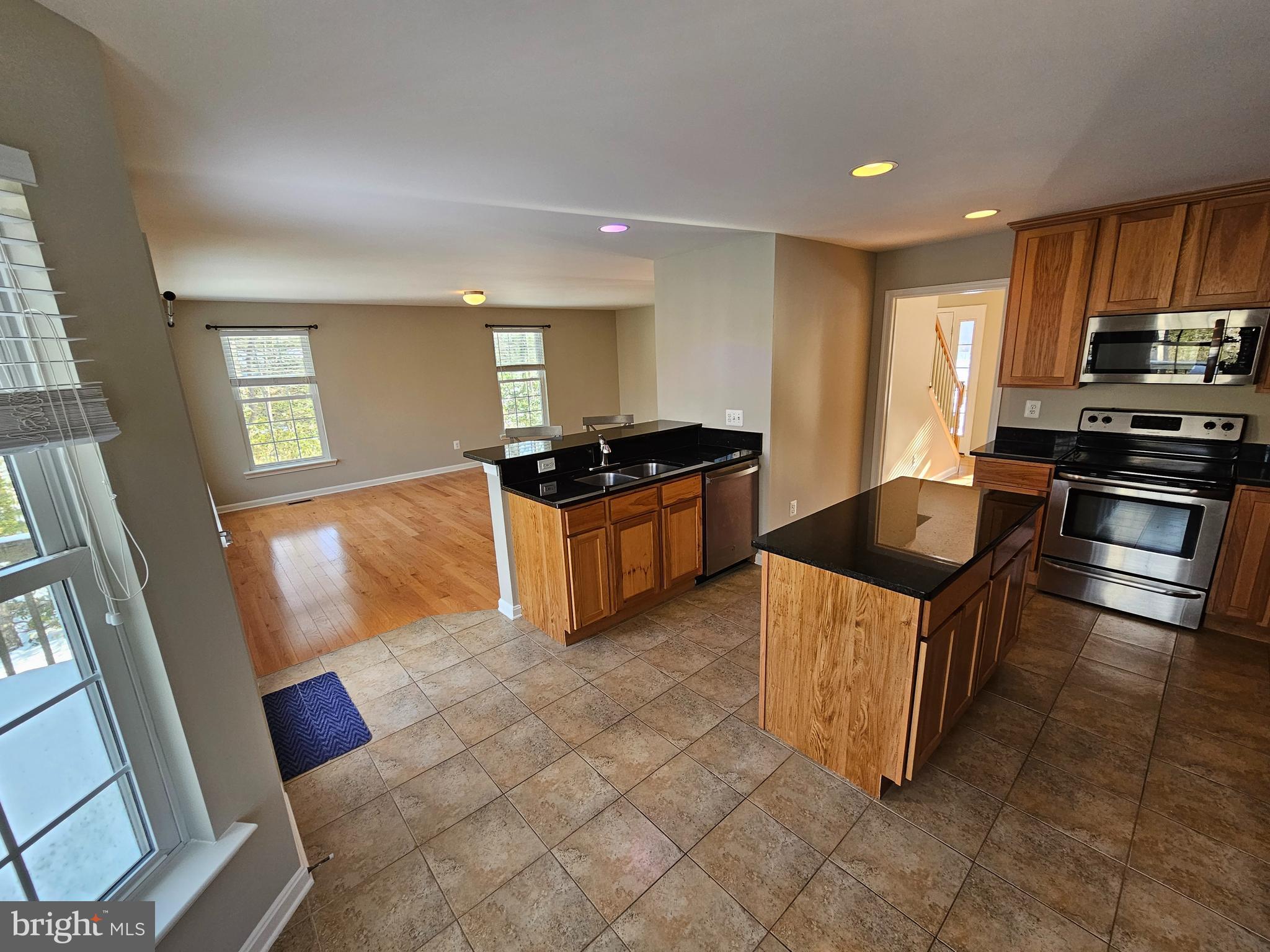 12560 Sagebrush Drive Lusby, MD 20657 - Photo 5 of 43 a kitchen with stainless steel appliances granite countertop a stove a sink and a refrigerator