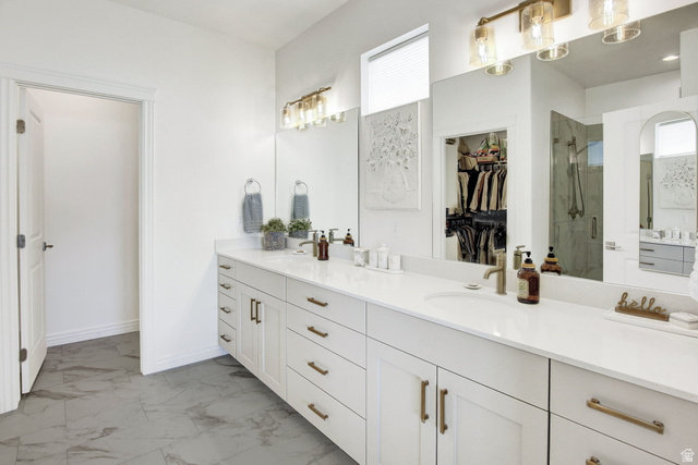 910 South 1700 West Layton, UT 84041 - Photo 15 of 26 Full bathroom featuring double vanity, a spacious closet, light marble finish floors, and a marble finish shower