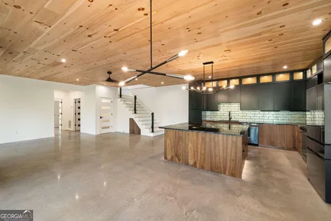 a view of a room with a kitchen