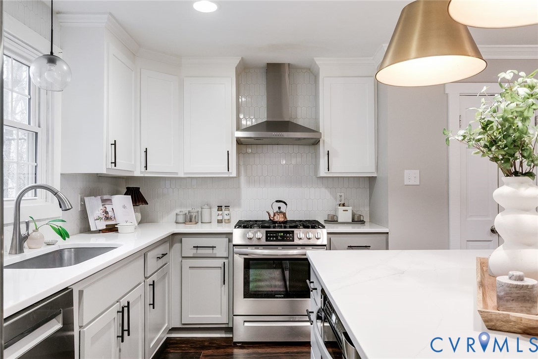 2831 Earlswood Road Midlothian, VA 23113 - Photo 12 of 47 a kitchen with stainless steel appliances a white stove top oven a sink a window and white cabinets