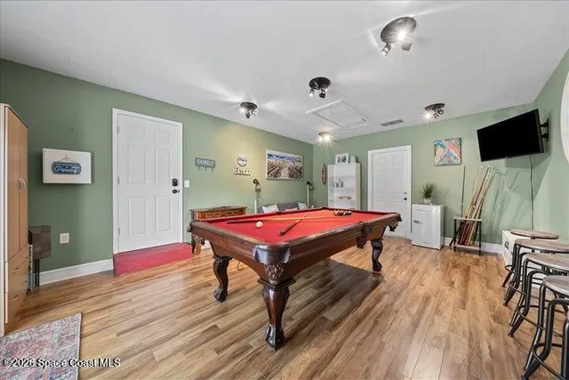 a room with pool table and a flat screen tv