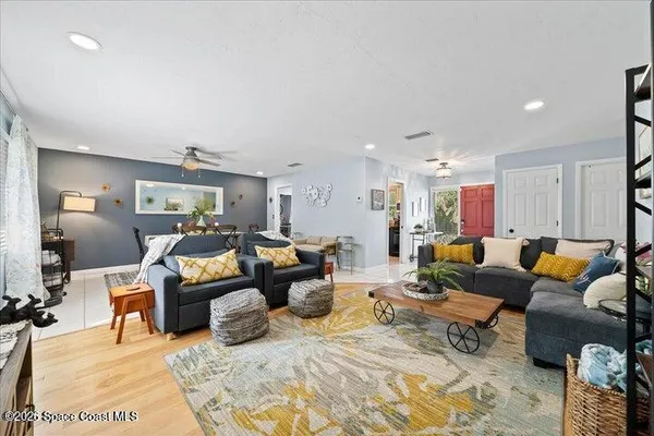 a living room with furniture kitchen view and a table