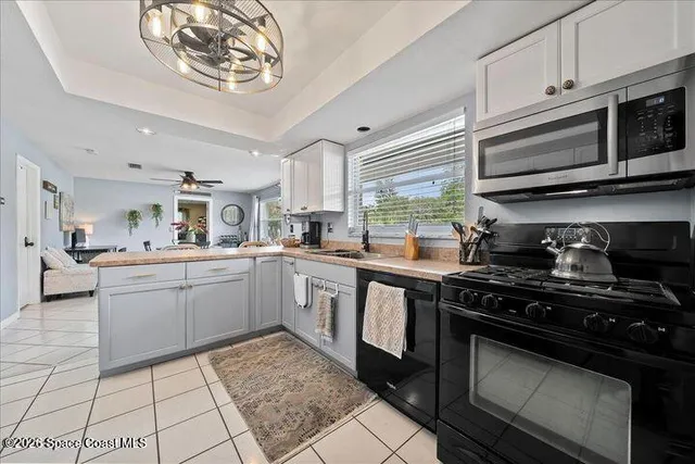 a kitchen with stainless steel appliances a stove a sink and cabinets