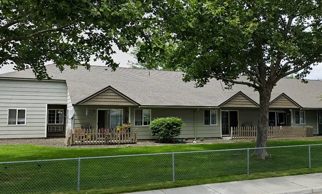 a front view of a house with a yard table and chairs