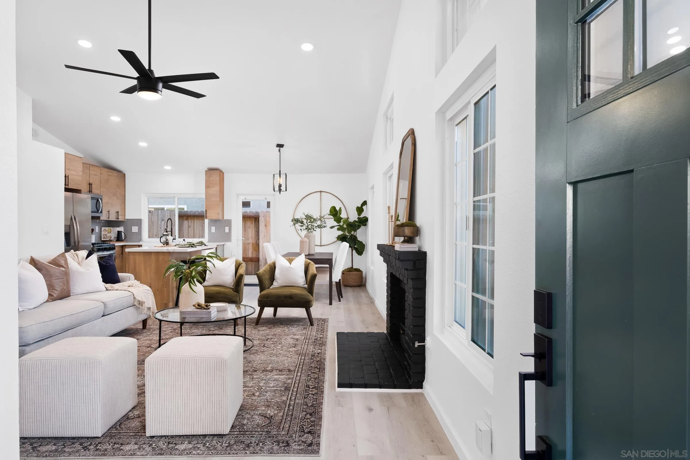 2457 Jasper Glen Escondido, CA 92029 - Photo 4 of 22 a living room with furniture kitchen view and a chandelier