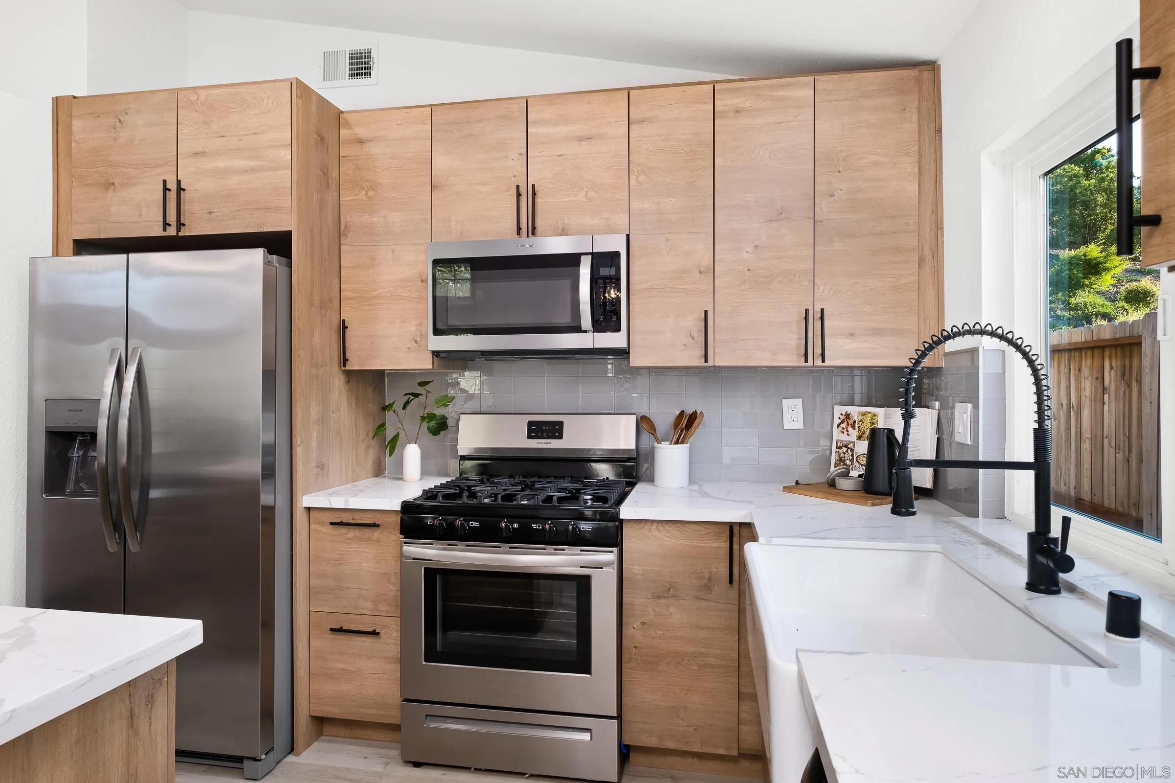 2457 Jasper Glen Escondido, CA 92029 - Photo 9 of 22 a kitchen with stainless steel appliances a refrigerator sink and microwave