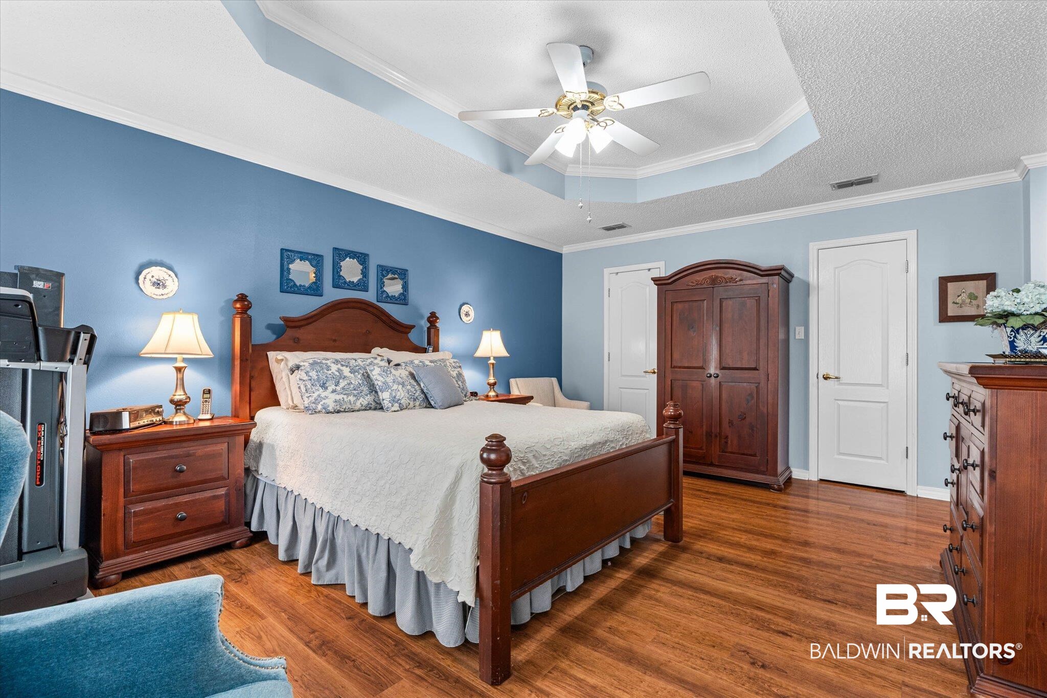 25825 Austin Road Daphne, AL 36526 - Photo 11 of 30 Bedroom featuring ornamental molding, wood finished floors, ceiling fan, a tray ceiling, and a closet