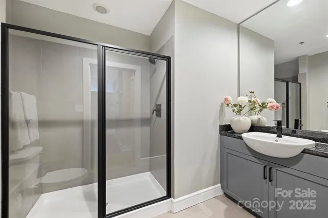 a bathroom with a mirror and a shower