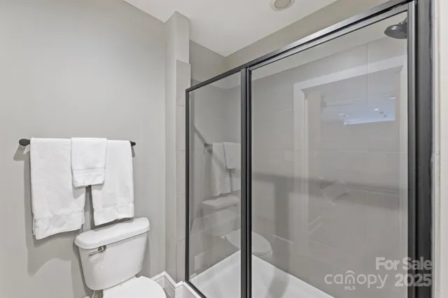 a bathroom with a shower and toilet