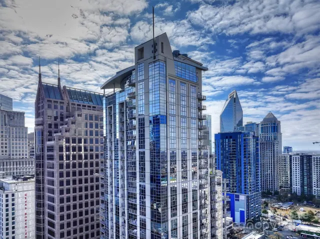 a view of a brick house with wooden fence