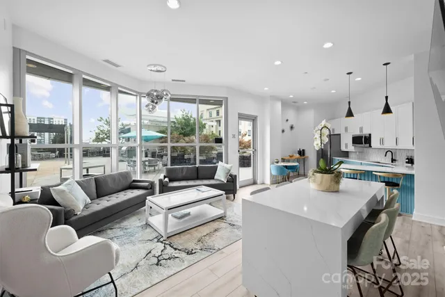 a kitchen with stainless steel appliances granite countertop a sink a stove a refrigerator and island with wooden floor