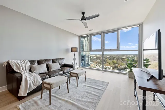 a living room with furniture and a large window