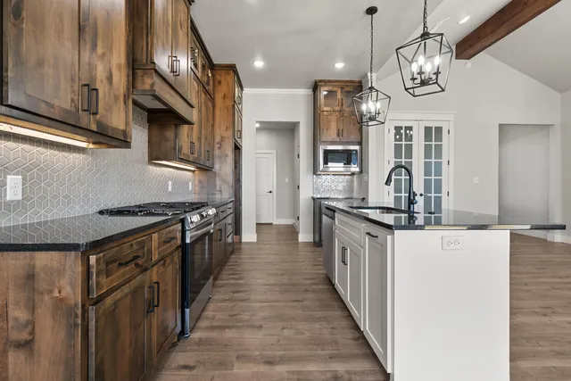 a kitchen with stainless steel appliances granite countertop a sink and cabinets
