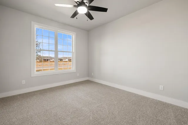 a bathroom with a granite countertop sink toilet and mirror
