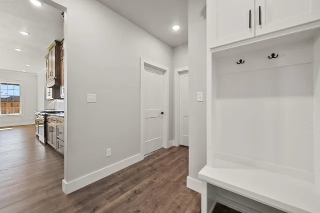 a view of small space with wooden floor and cabinets