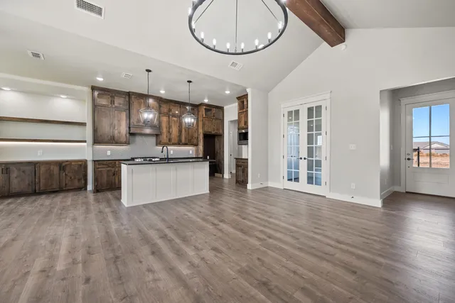a view of kitchen with stove and cabinets
