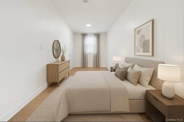 a bedroom with a bed and a painting