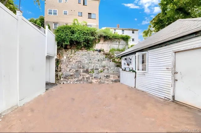 a view of a house with a yard and potted plants