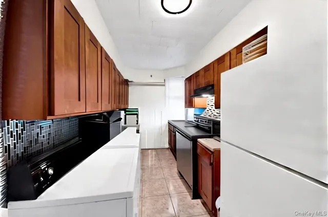 a kitchen with granite countertop a sink and a stove